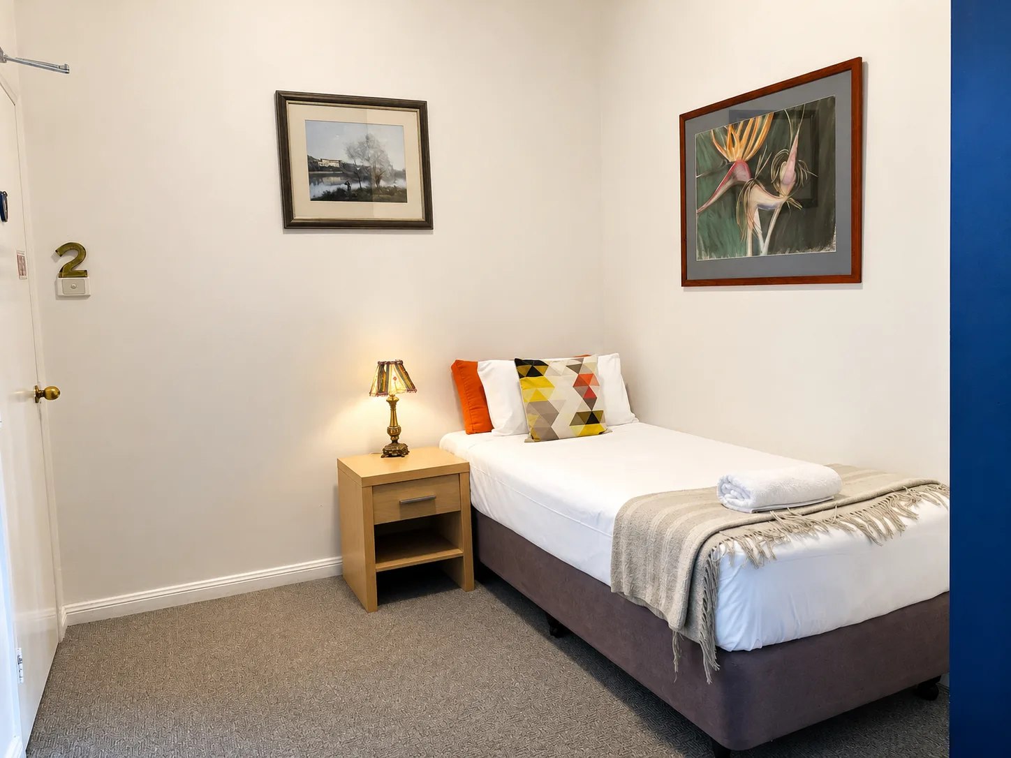 Single bed with bedside lamp — Family Room Standard at Vine Valley Inn Cessnock