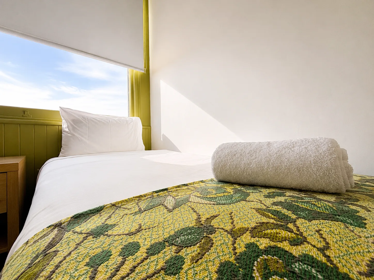 Single bed with window view — Family Room at Vine Valley Inn Cessnock