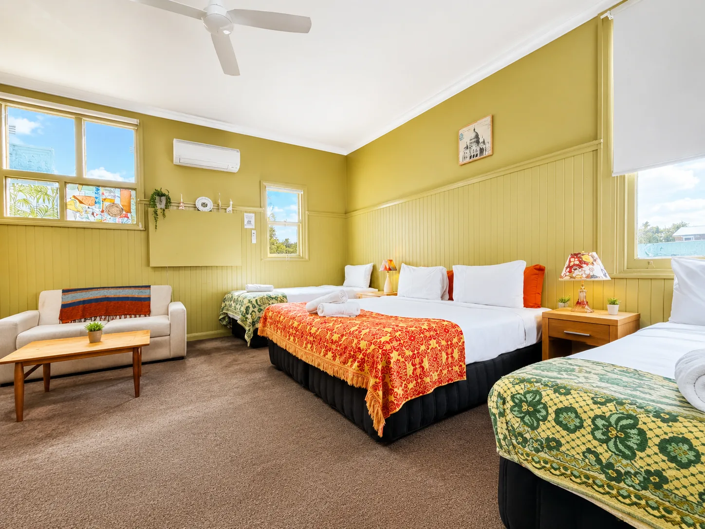 Bright bedroom with multiple beds — Family Room at Vine Valley Inn Cessnock