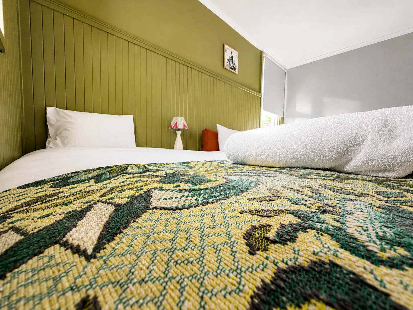 Comfortable bedding and bedside lamp — Family Room at Vine Valley Inn Cessnock