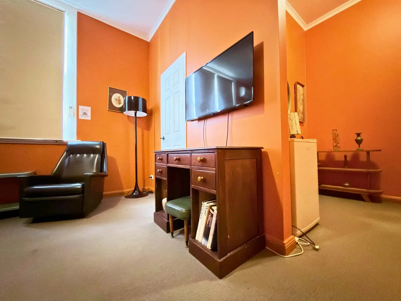 Smart TV and antique writing desk — King Room at Vine Valley Inn Cessnock