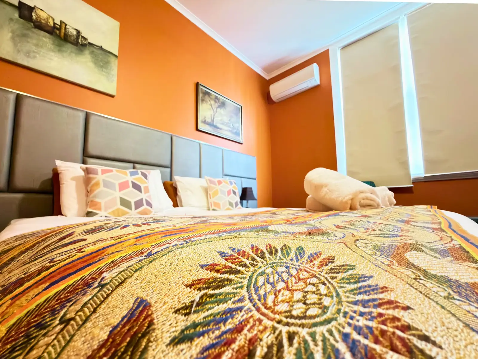 King bed with vibrant bedding — King Room at Vine Valley Inn Cessnock