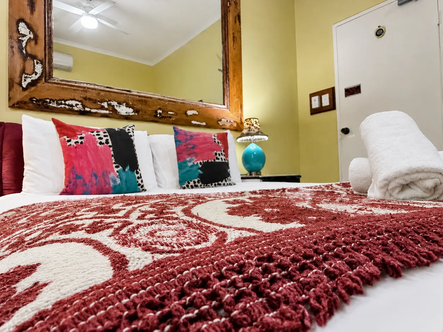 Plush bedding and cushions — Queen Deluxe Room at Vine Valley Inn Cessnock