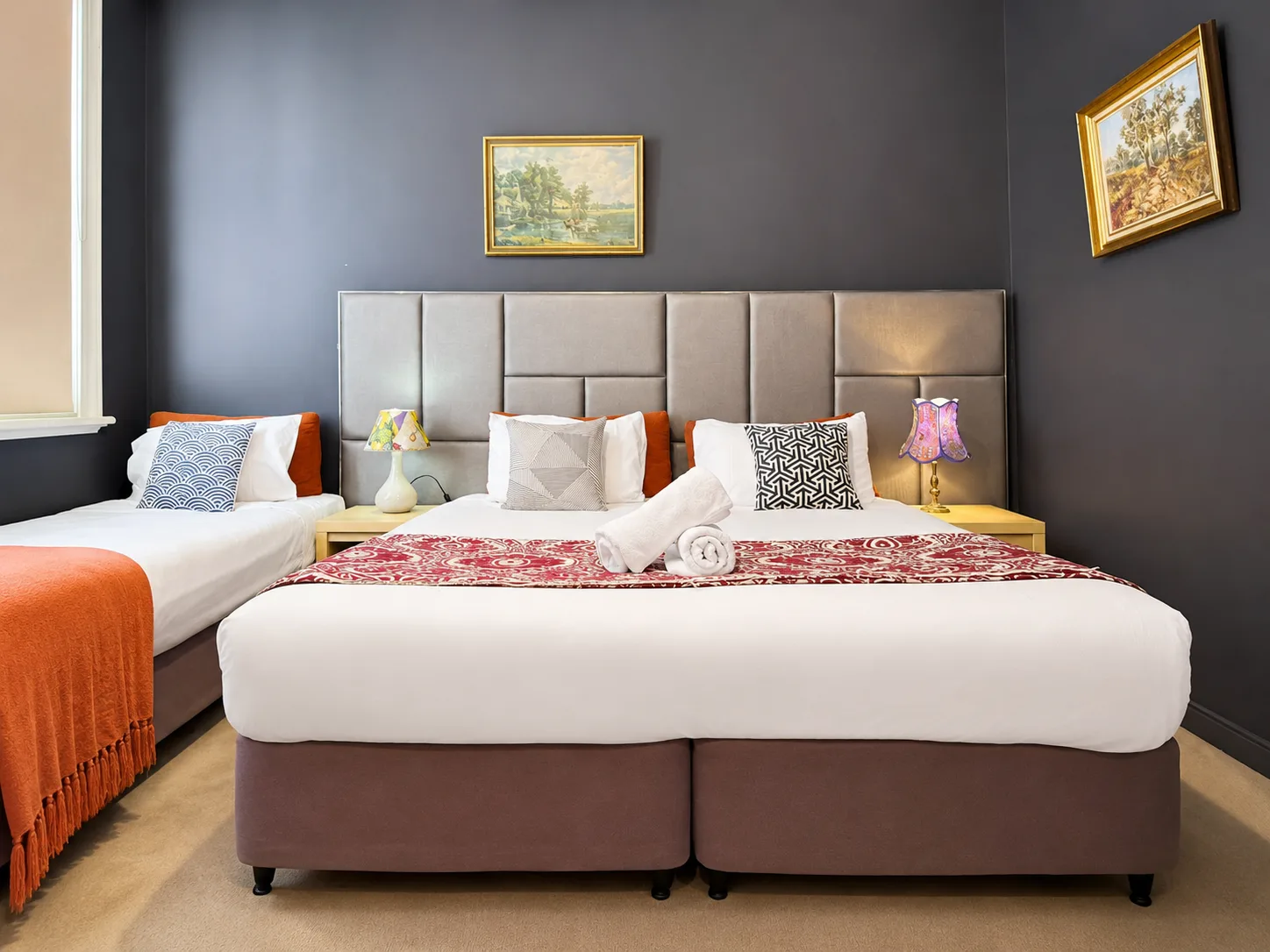 Twin and queen beds with navy walls — Twin Room at Vine Valley Inn Cessnock